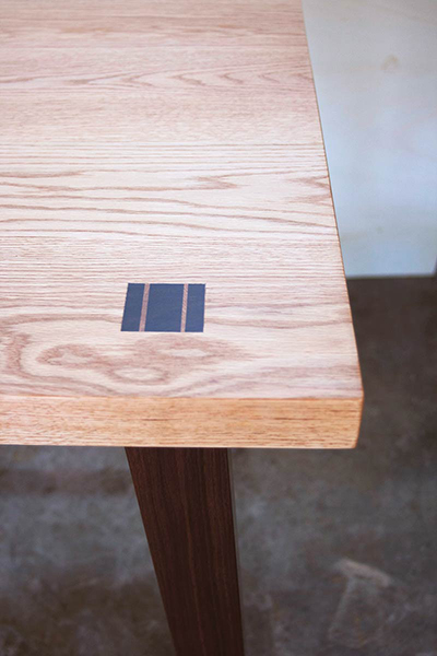 detail of Taylor Desk, shown in red oak and walnut